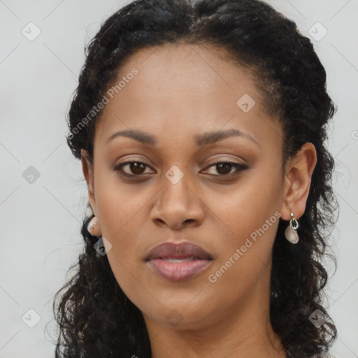 Joyful black young-adult female with long  brown hair and brown eyes