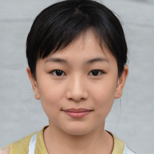 Joyful asian young-adult female with short  brown hair and brown eyes
