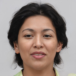 Joyful asian adult female with medium  brown hair and brown eyes