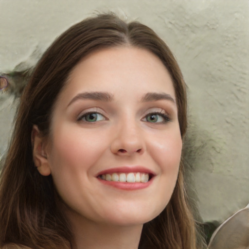 Joyful white young-adult female with long  brown hair and green eyes