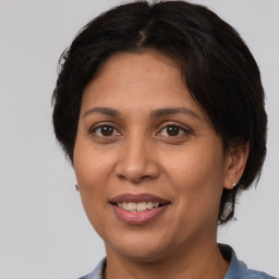 Joyful white adult female with medium  brown hair and brown eyes