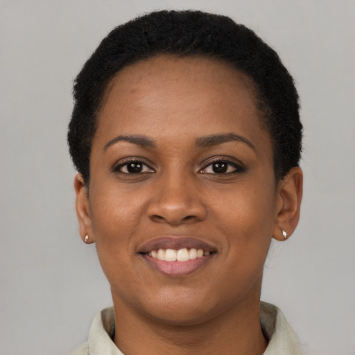 Joyful latino young-adult female with short  black hair and brown eyes