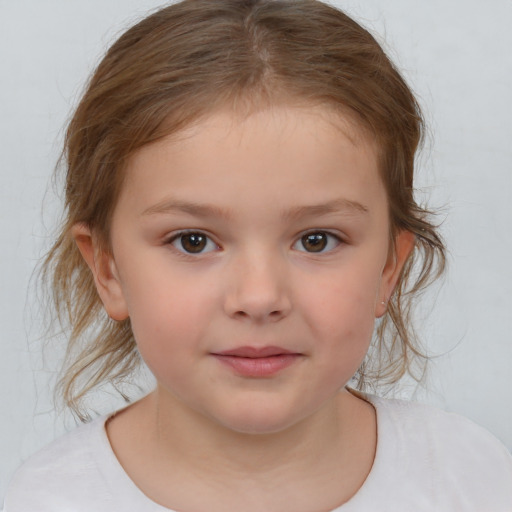 Joyful white child female with medium  brown hair and brown eyes