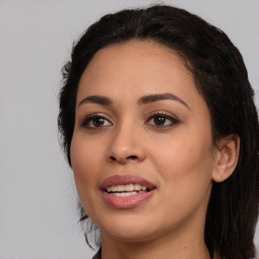 Joyful white young-adult female with long  black hair and brown eyes