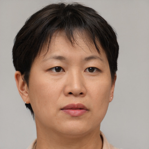 Neutral asian adult female with short  brown hair and brown eyes