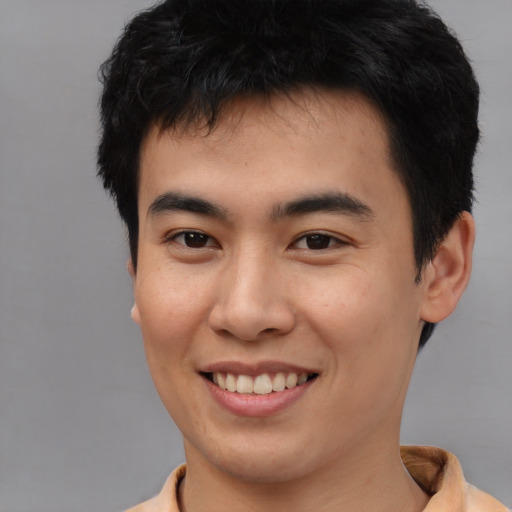 Joyful asian young-adult male with short  black hair and brown eyes