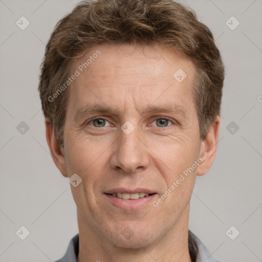 Joyful white adult male with short  brown hair and grey eyes