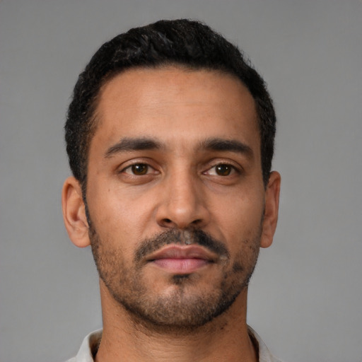 Neutral latino young-adult male with short  black hair and brown eyes