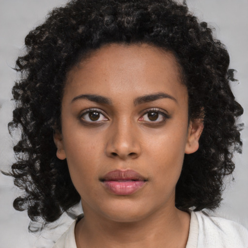 Neutral black young-adult female with medium  brown hair and brown eyes