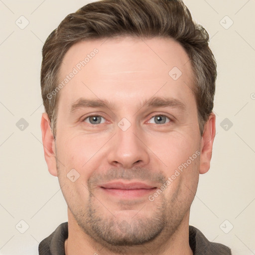 Joyful white adult male with short  brown hair and grey eyes