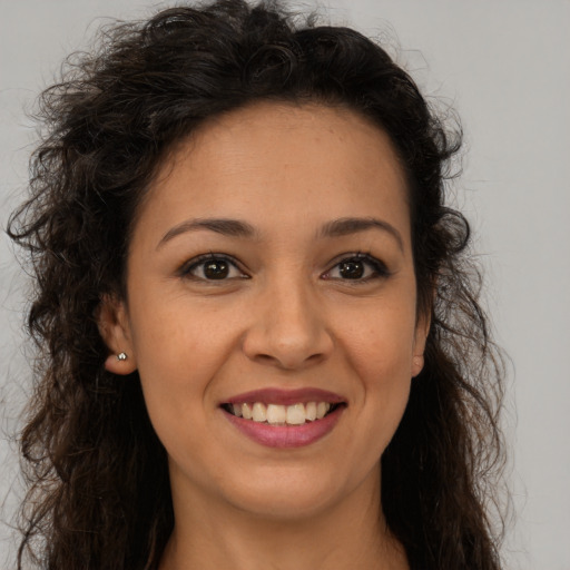 Joyful latino young-adult female with long  brown hair and brown eyes