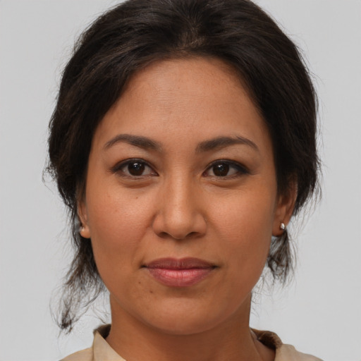 Joyful asian adult female with medium  brown hair and brown eyes