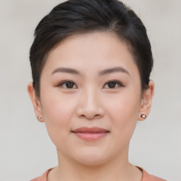 Joyful asian young-adult female with short  brown hair and brown eyes