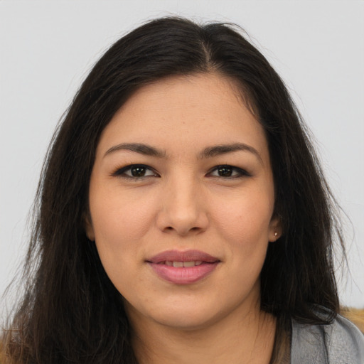 Joyful asian young-adult female with long  brown hair and brown eyes