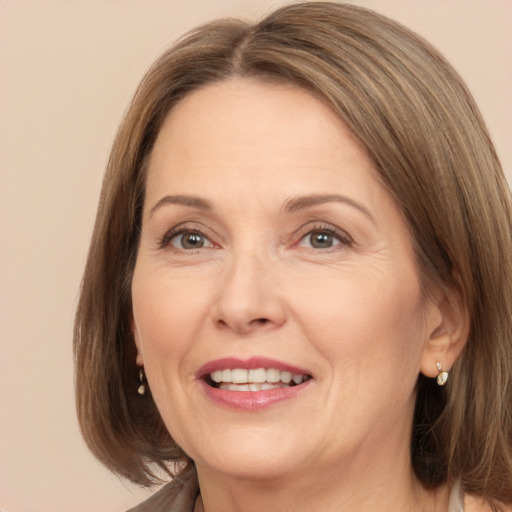 Joyful white adult female with medium  brown hair and brown eyes