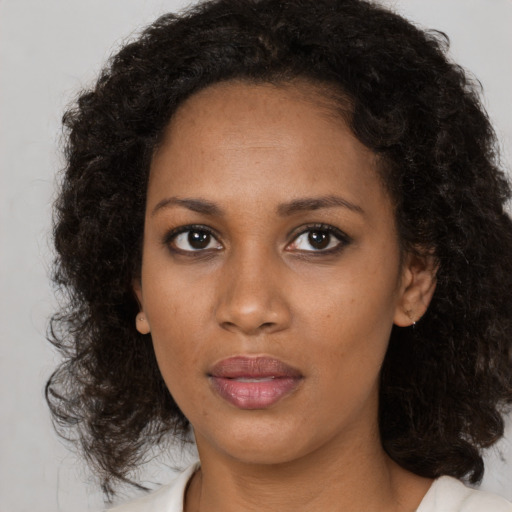 Neutral black young-adult female with medium  brown hair and brown eyes