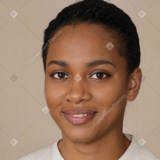 Joyful black young-adult female with short  black hair and brown eyes