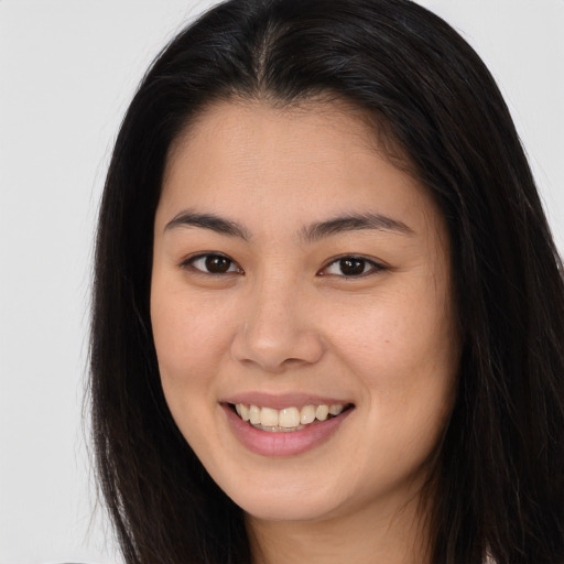 Joyful asian young-adult female with long  brown hair and brown eyes