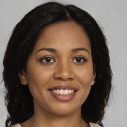 Joyful latino young-adult female with medium  brown hair and brown eyes