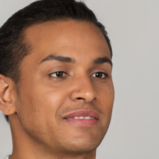 Joyful latino young-adult male with short  brown hair and brown eyes