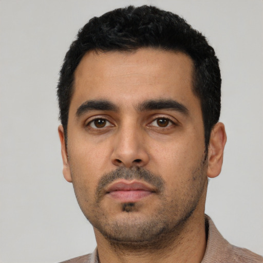 Neutral latino young-adult male with short  black hair and brown eyes