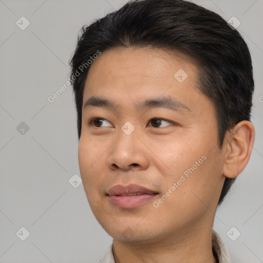 Joyful asian young-adult male with short  brown hair and brown eyes