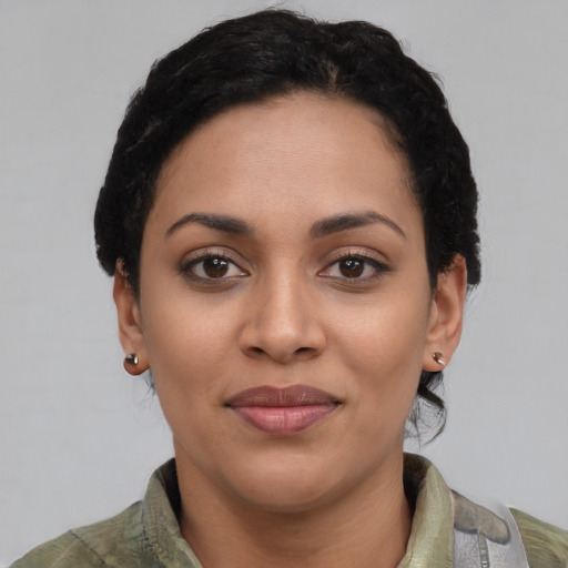 Joyful latino young-adult female with short  black hair and brown eyes