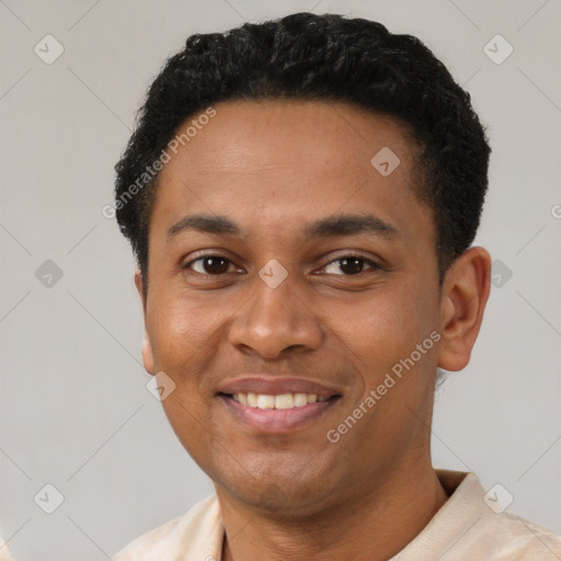 Joyful latino young-adult male with short  black hair and brown eyes