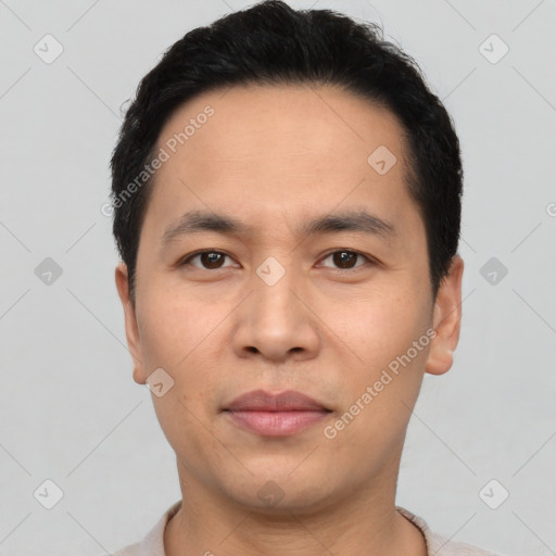 Joyful asian young-adult male with short  black hair and brown eyes