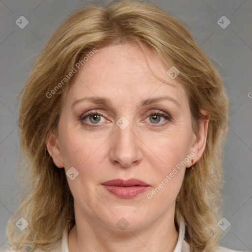 Joyful white adult female with medium  brown hair and blue eyes