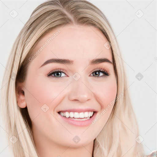 Joyful white young-adult female with long  brown hair and blue eyes