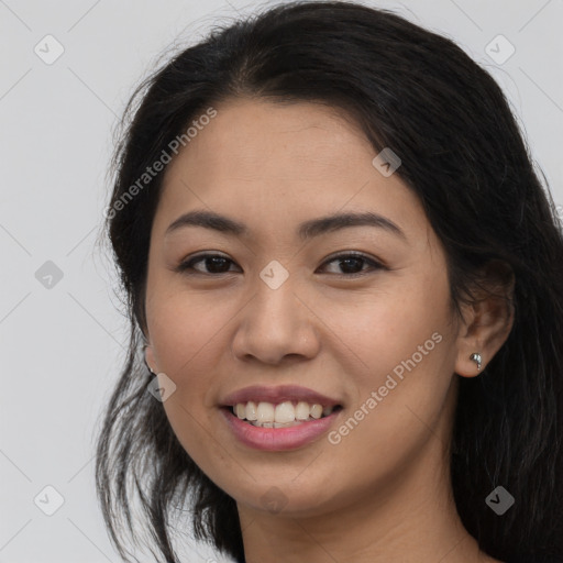 Joyful latino young-adult female with long  brown hair and brown eyes