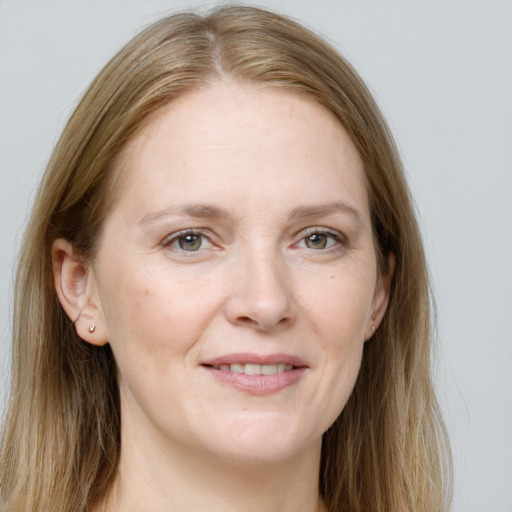 Joyful white adult female with long  brown hair and grey eyes