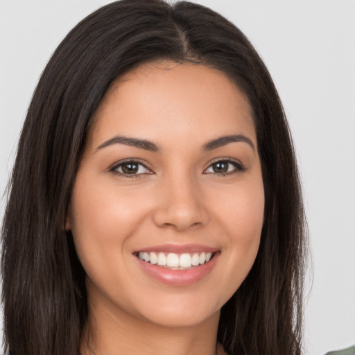 Joyful white young-adult female with long  brown hair and brown eyes