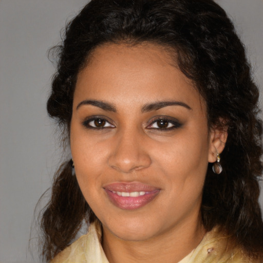 Joyful black young-adult female with medium  brown hair and brown eyes