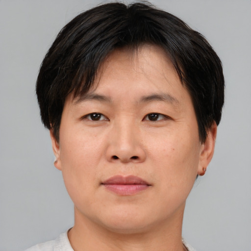 Joyful asian adult male with short  brown hair and brown eyes