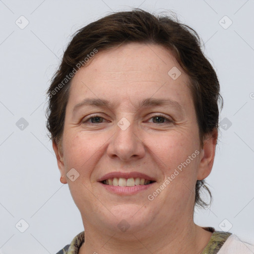 Joyful white adult female with short  brown hair and grey eyes