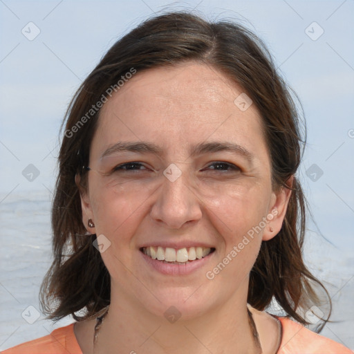 Joyful white adult female with medium  brown hair and grey eyes