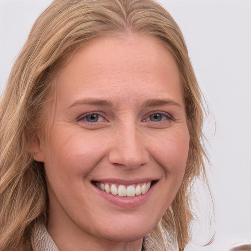 Joyful white young-adult female with long  brown hair and blue eyes