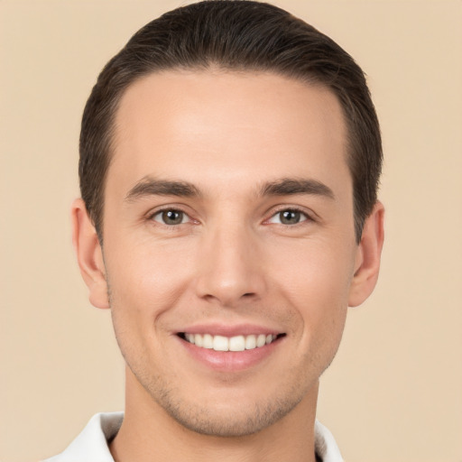 Joyful white young-adult male with short  brown hair and brown eyes