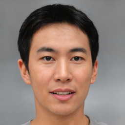 Joyful asian young-adult male with short  brown hair and brown eyes