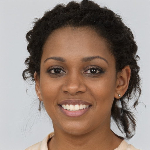 Joyful black young-adult female with medium  brown hair and brown eyes