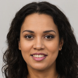 Joyful latino young-adult female with long  brown hair and brown eyes