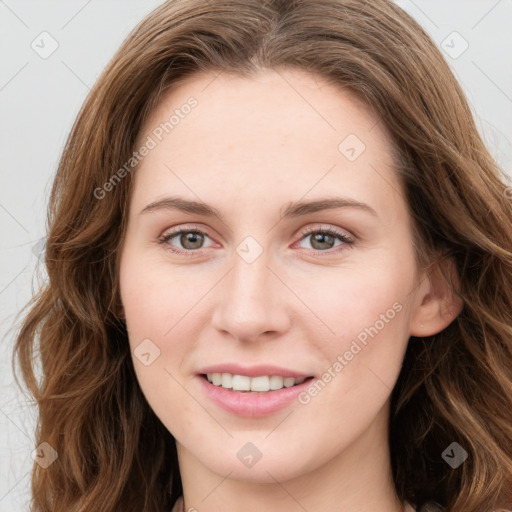 Joyful white young-adult female with long  brown hair and green eyes