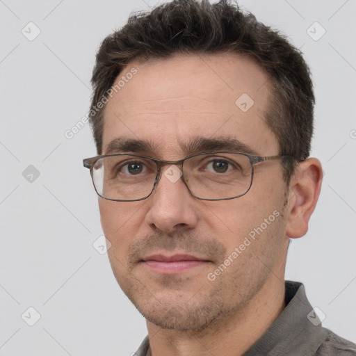 Joyful white adult male with short  brown hair and brown eyes