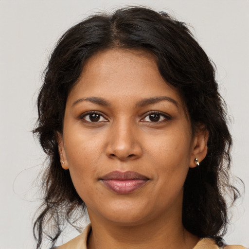 Joyful black young-adult female with medium  brown hair and brown eyes
