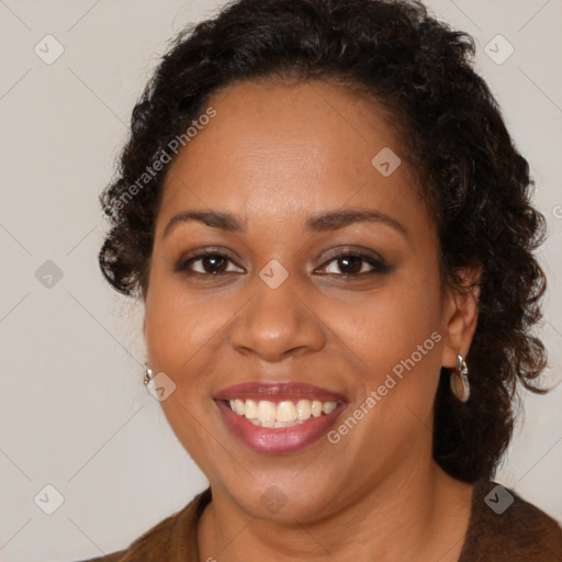 Joyful black young-adult female with long  brown hair and brown eyes