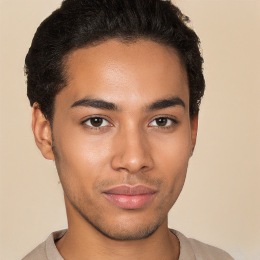 Joyful latino young-adult male with short  brown hair and brown eyes