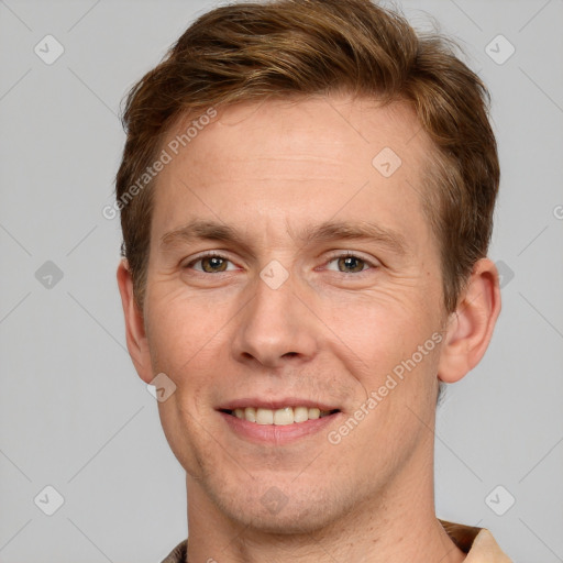 Joyful white adult male with short  brown hair and grey eyes