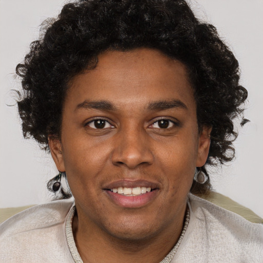 Joyful black young-adult male with short  brown hair and brown eyes